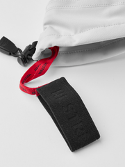 White ski glove with black cuff strap and red pull tab