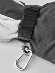 Gray ski glove close-up with woven wrist strap and metal carabiner clip
