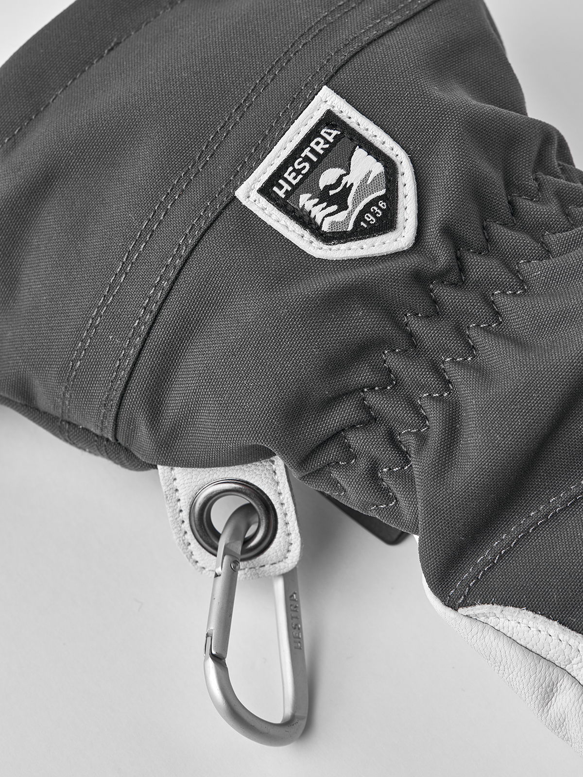 Women’s ski gloves in dark gray with Hestra patch and metal carabiner