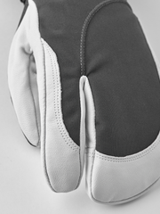 Dark-and-white ski glove with curved knuckle seam and textured palm panel
