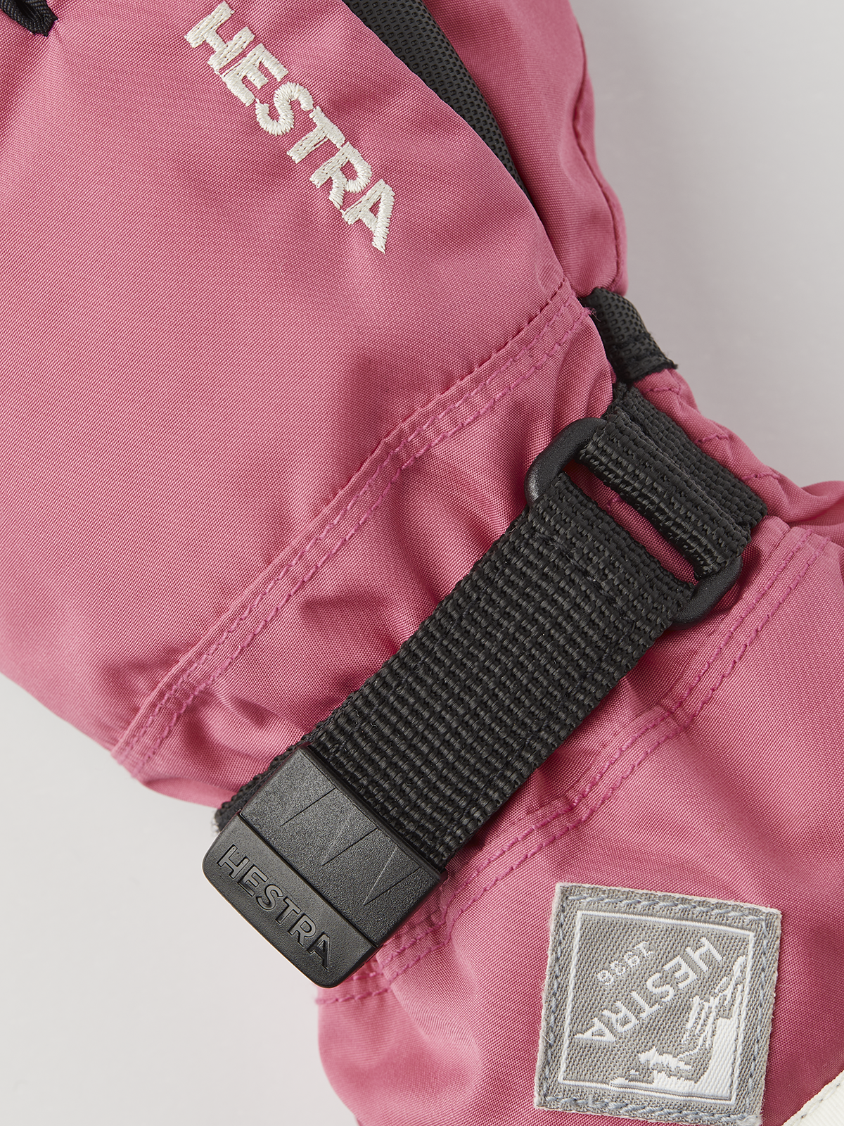 Hestra Gauntlet CZone Jr 3-finger gloves, pink fabric with black strap and logo patch