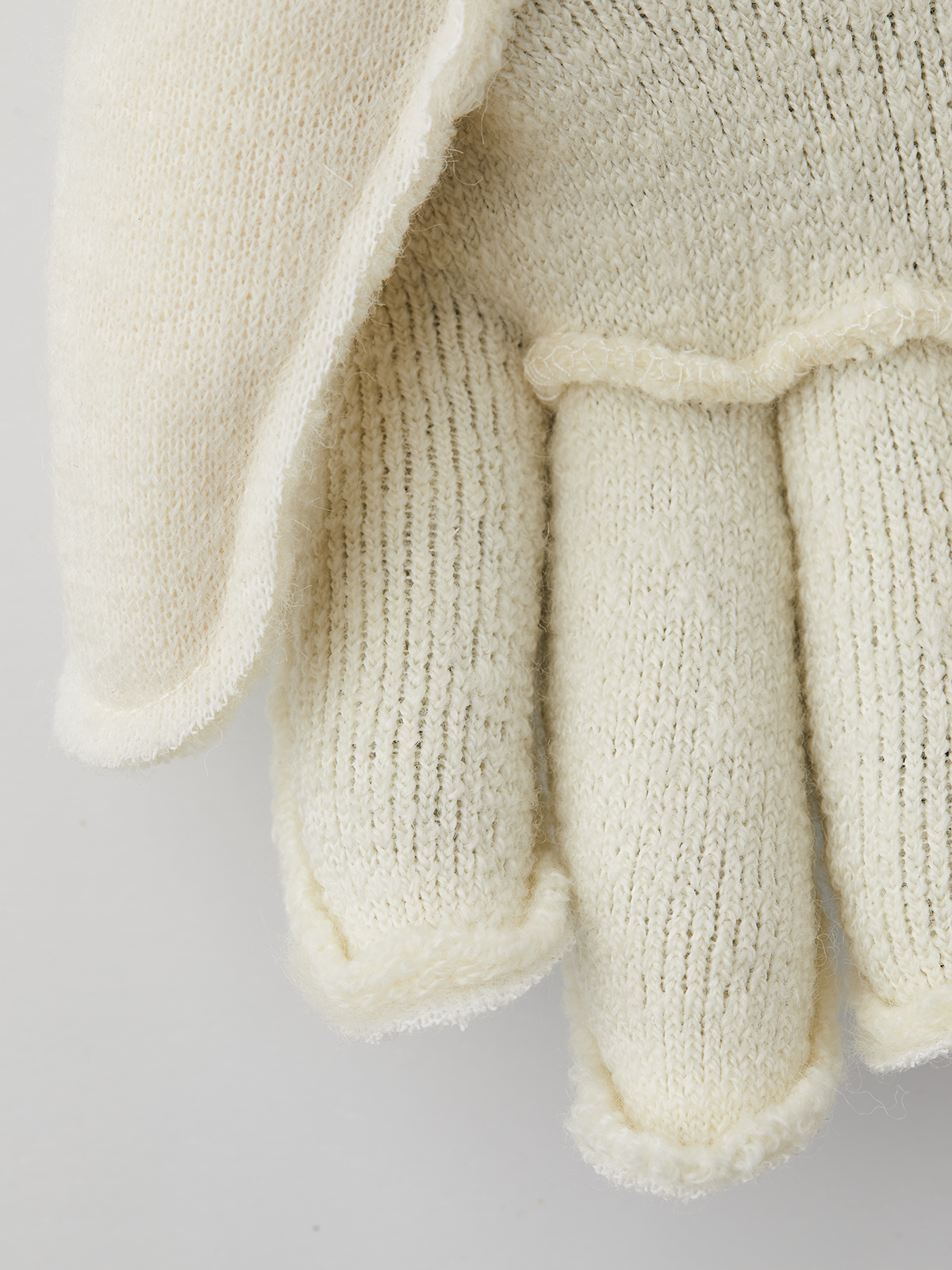 Pair of off-white short wool glove liners with fingered terry-pile coverage