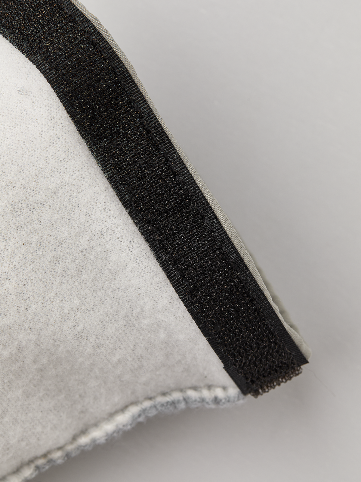 Hestra kids' glove liner cuff in dark fabric with stitched edge on off-white fleece