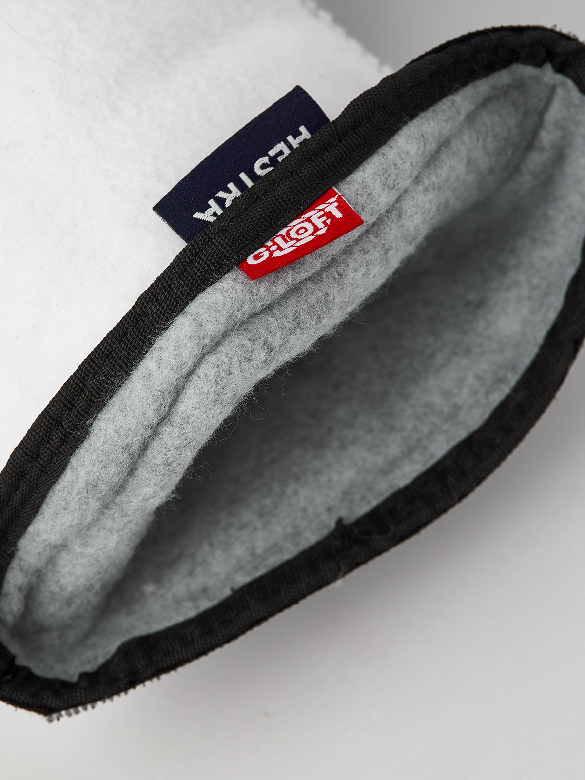 Ski glove liner cuff with Hestra and Glovfit logos and gray lining
