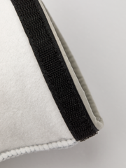 Off-white ski glove liner with black elastic wrist strap for secure fit