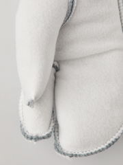 Off-white 3-finger ski glove liners, close-up cuff seam with light blue stitching