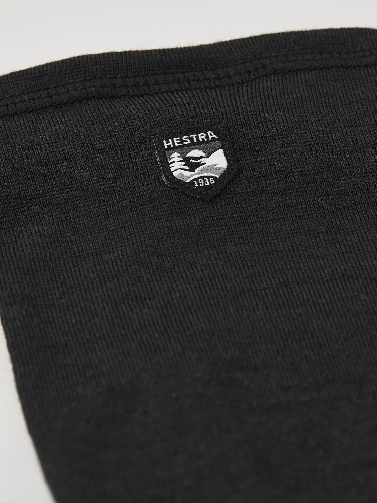 Black merino wool long glove liners, ribbed cuff and brand patch on back