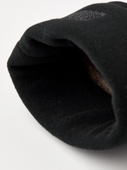 Rolled black cuff edge of beige merino knit glove liner