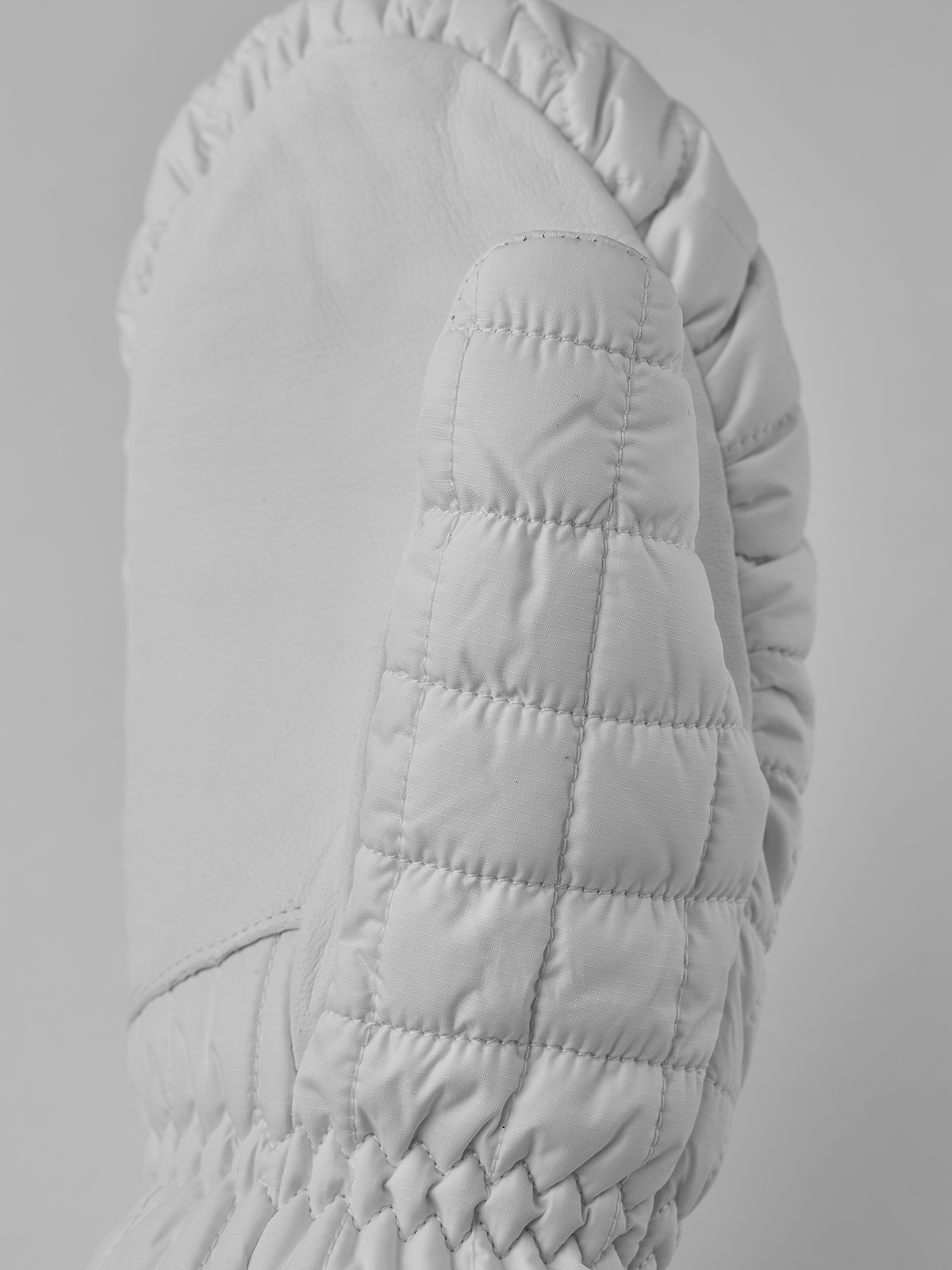 White quilted mitten with padded palm and fingerless-style back panel detail