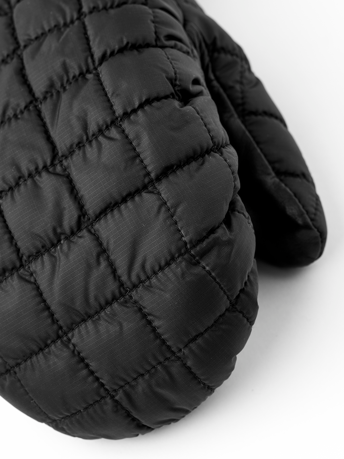 Black quilted mitten with diamond stitching and gathered cuff seam