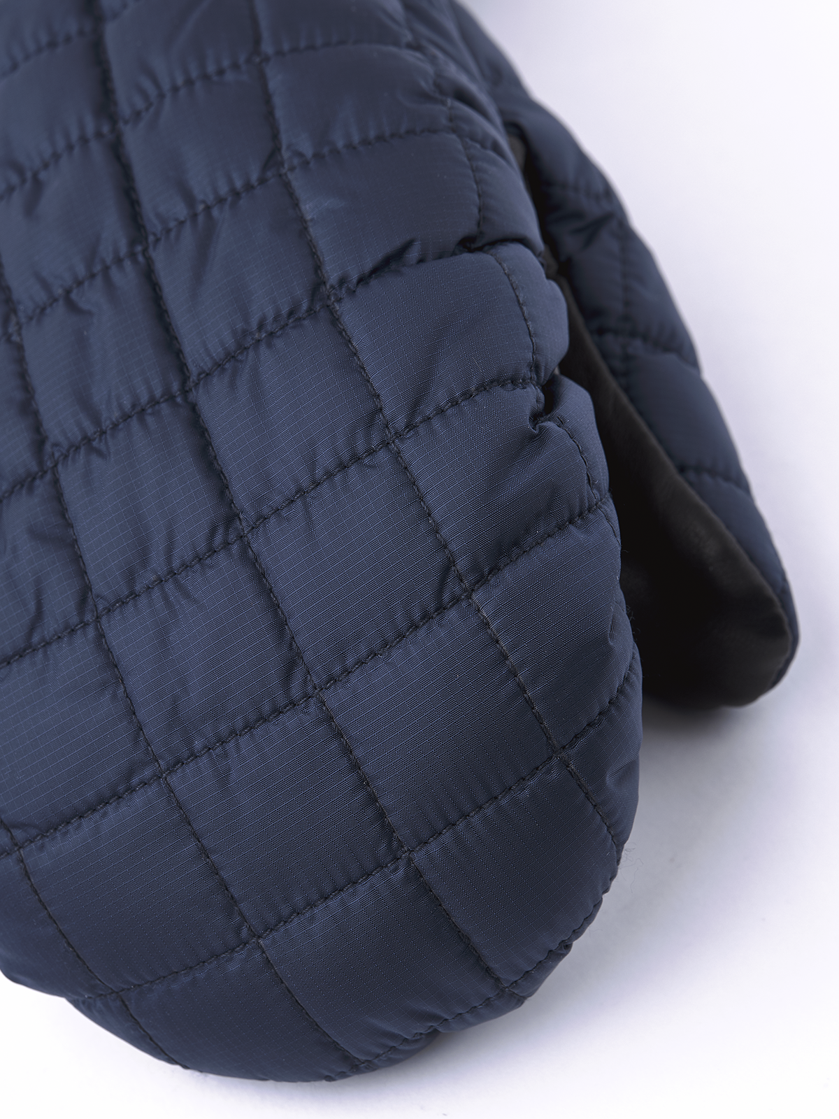 Blue quilted mitten with stitched baffle panels and padded knuckles