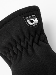 Kids fleece mitten liners, black, with Hestra logo patch at wrist