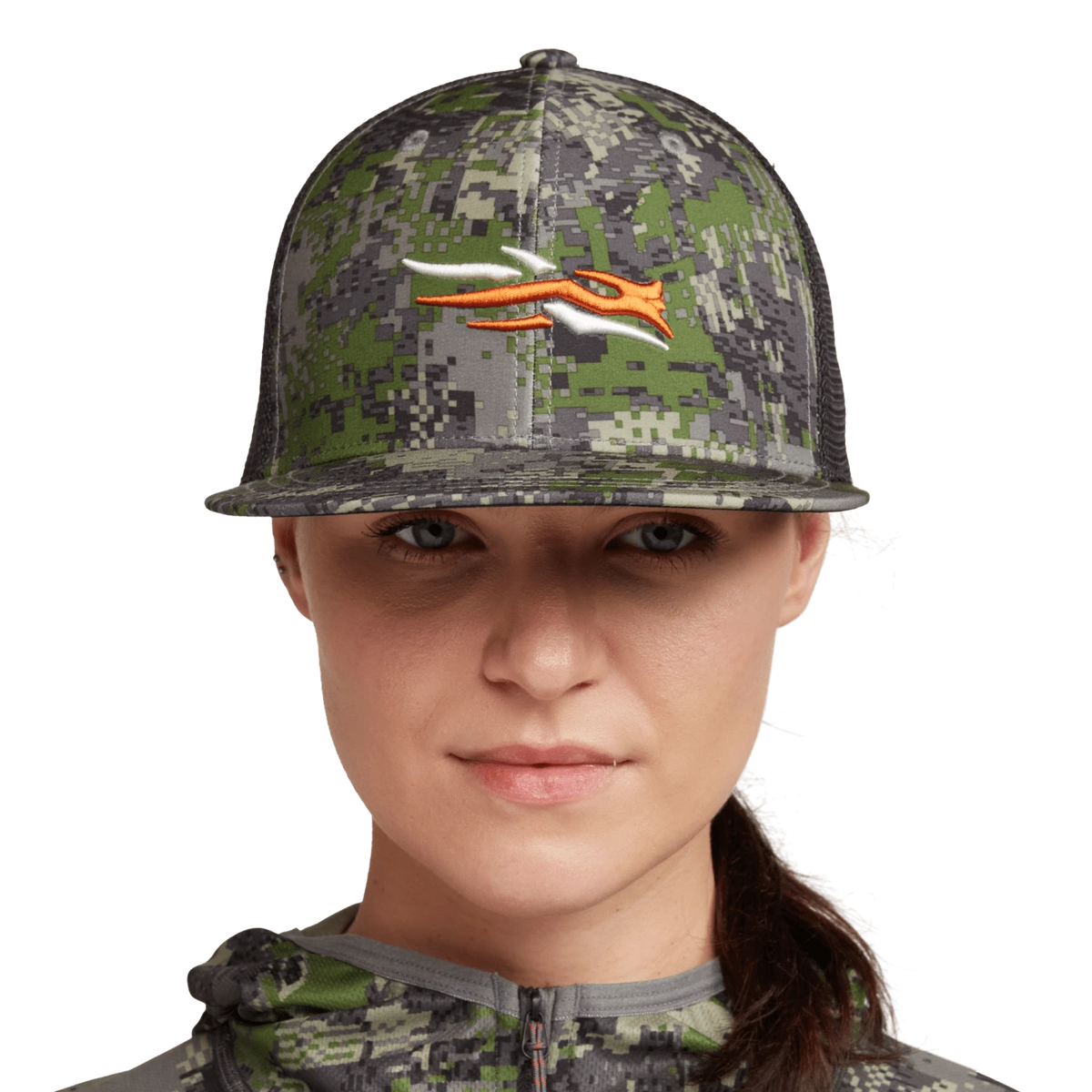 Women's green camo trucker hat with black mesh back, orange animal graphic, model front