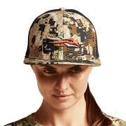 Women's tan camo trucker hat with black mesh back and orange animal graphic, model front