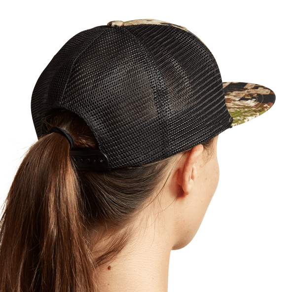 Women's dark mesh trucker hat with adjustable strap and camo brim, angled side view