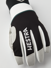 Black and off-white gloves with Hestra logo on finger panels and gray fingertips