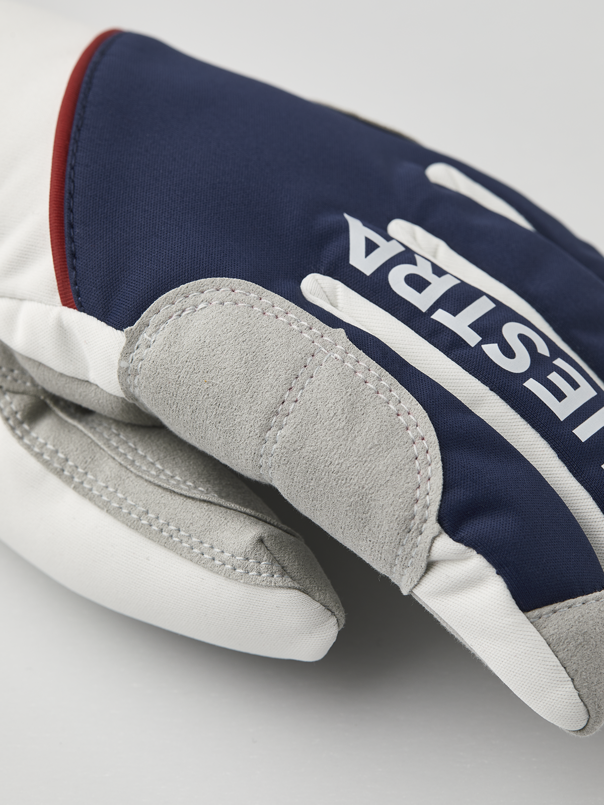 Navy and off-white comfort tracker gloves with Hestra logo on the back