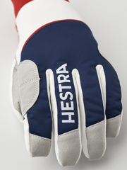 Navy and off-white winter gloves with gray trim, Hestra text on the cuff