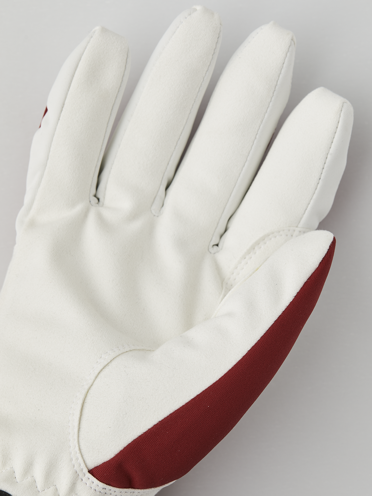 Off-white comfort tracker gloves with red interior wrist trim