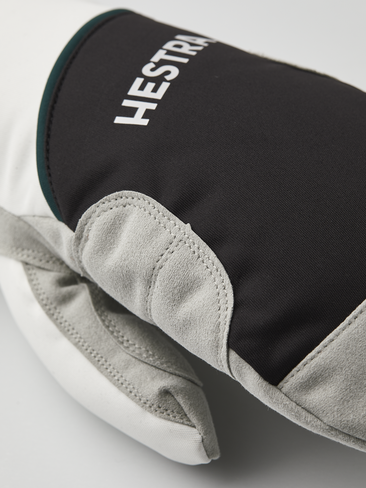 Hestra comfort tracker mittens in dark with off-white palm and teal trim
