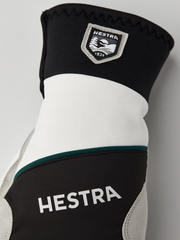 Hestra comfort tracker mittens in black and off-white with green trim stripe