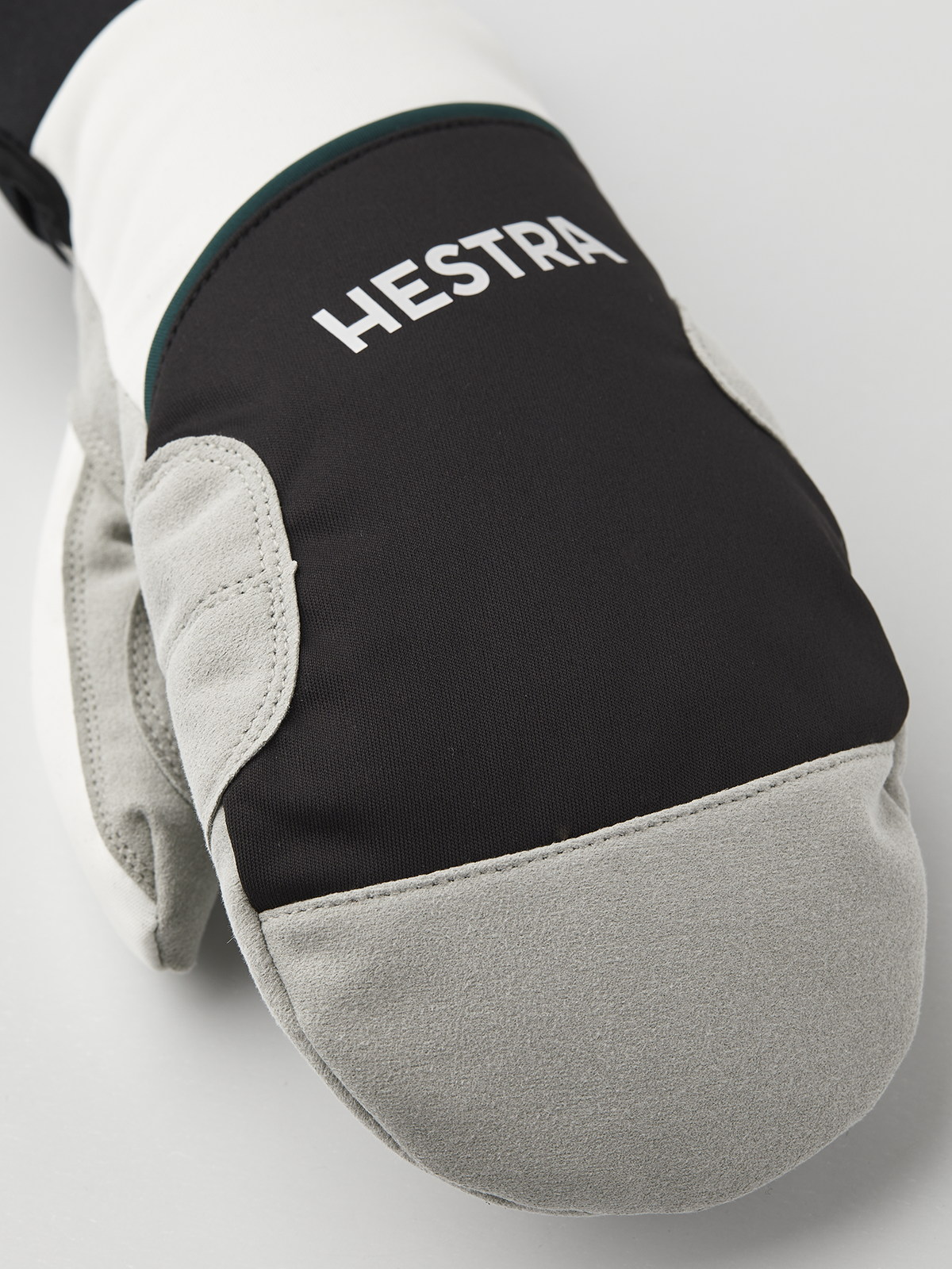 Hestra comfort tracker mittens with black back and off-white Hestra logo patch