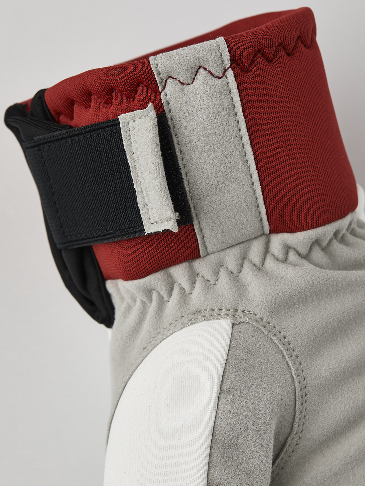Hestra comfort tracker mittens in red with off-white lining and black wrist strap