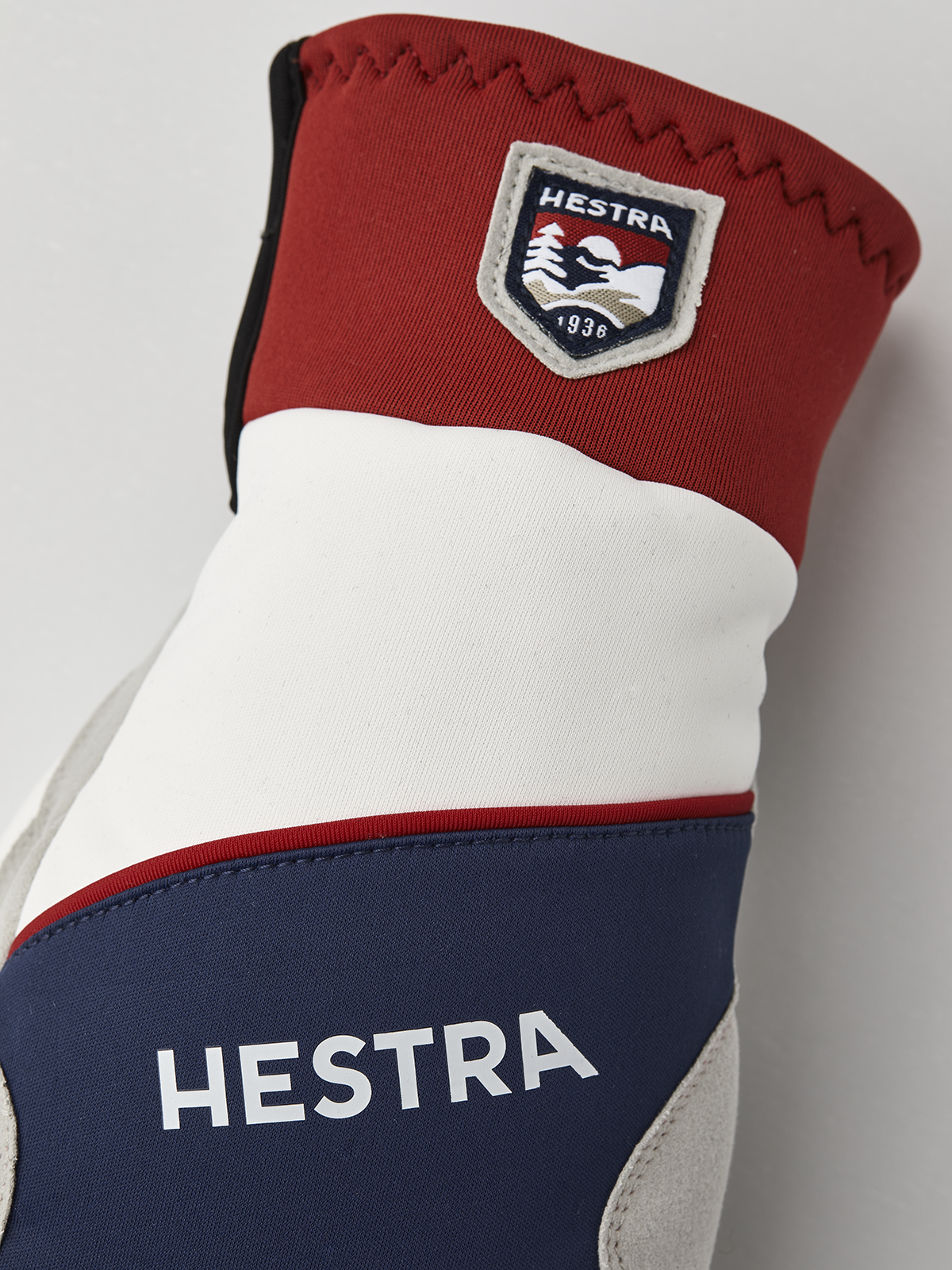 Hestra comfort tracker mittens in red and navy with Hestra logo and cuff