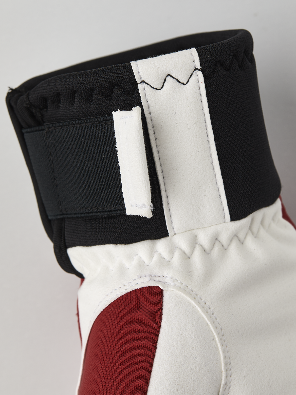 Hestra comfort tracker mittens in black and off-white with red palm panel