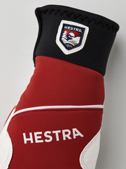 Hestra comfort tracker mittens in black, red, and off-white with logo patch