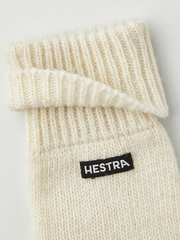 Off-white knit glove liner with Hestra logo patch and ribbed cuff