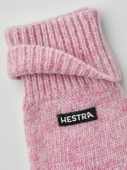 Pink knit glove liner with Hestra logo patch and ribbed knit texture