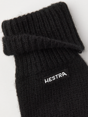 Black knit mitten liner with ribbed cuff and HESTRA logo patch.