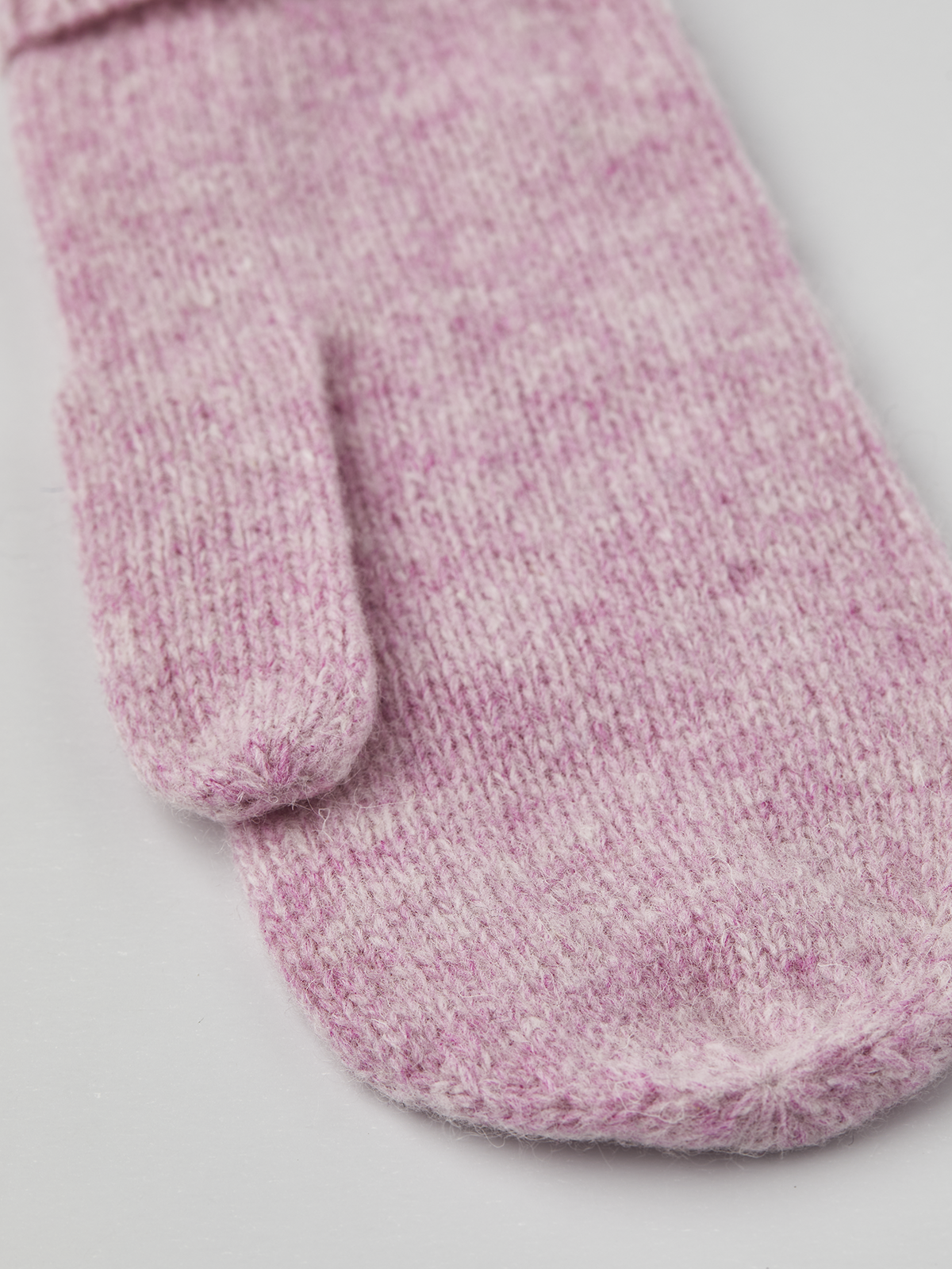 Pink knit mitten liner with ribbed cuff, close-up.