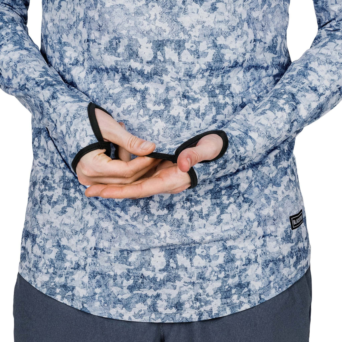 Mens hooded sun shirt close-up: blue speckled camo with black trim and tag