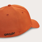 Orange stretch baseball cap with Oakley logo and stitched panels, curved brim