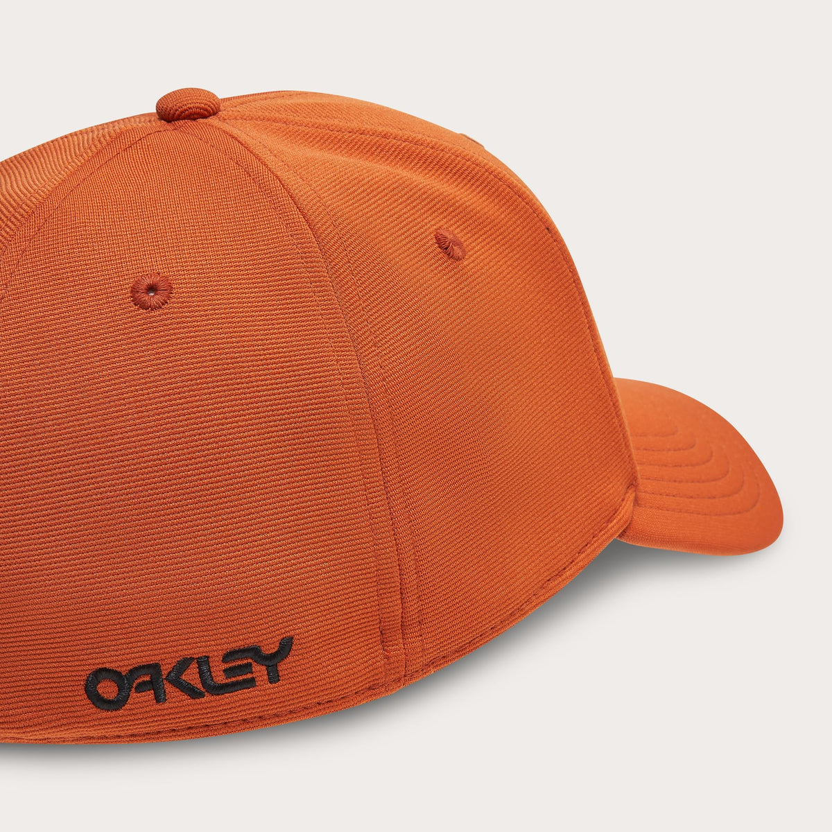 Orange stretch baseball cap with Oakley logo and stitched panels, curved brim