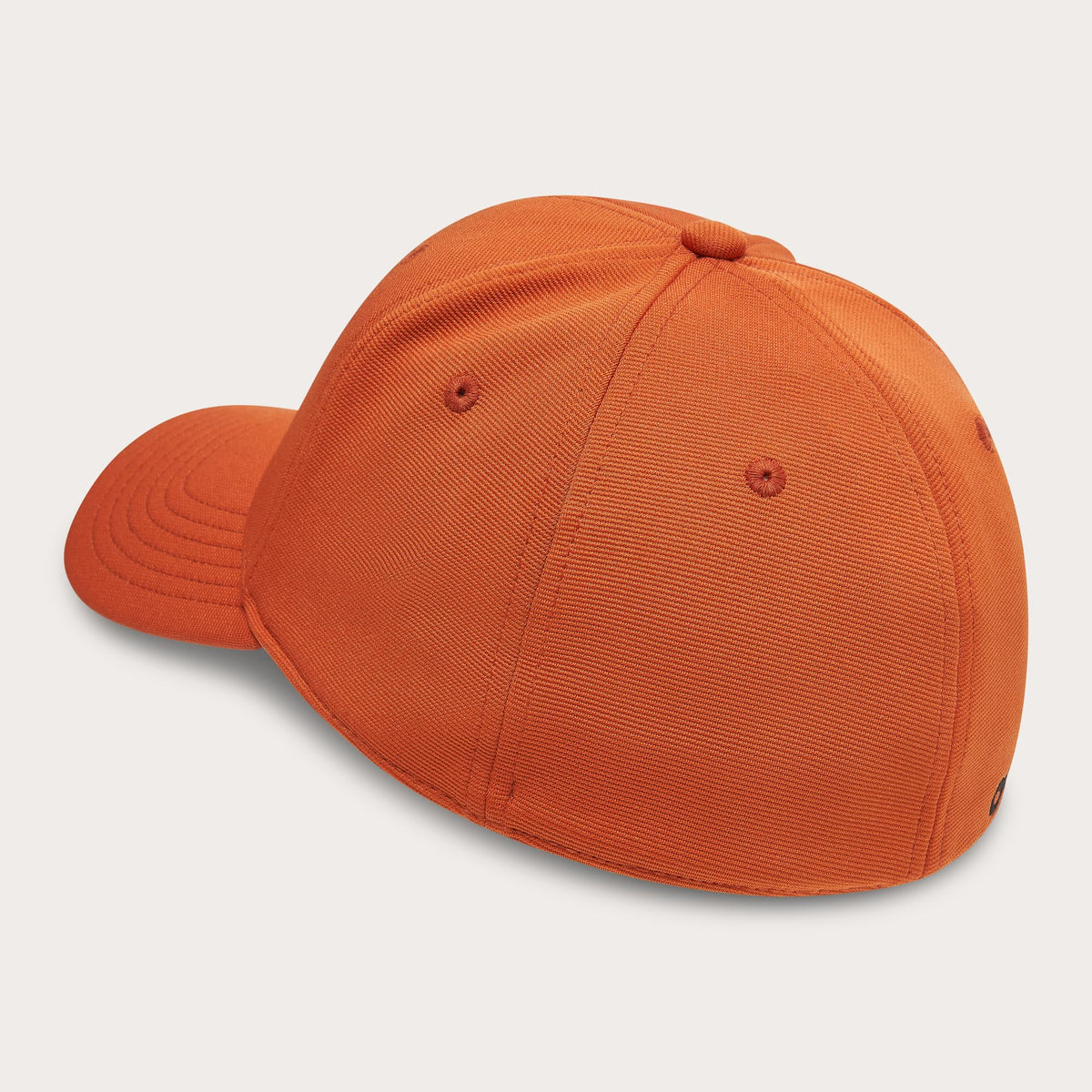 Orange stretch baseball cap, side view, curved brim with small eyelets