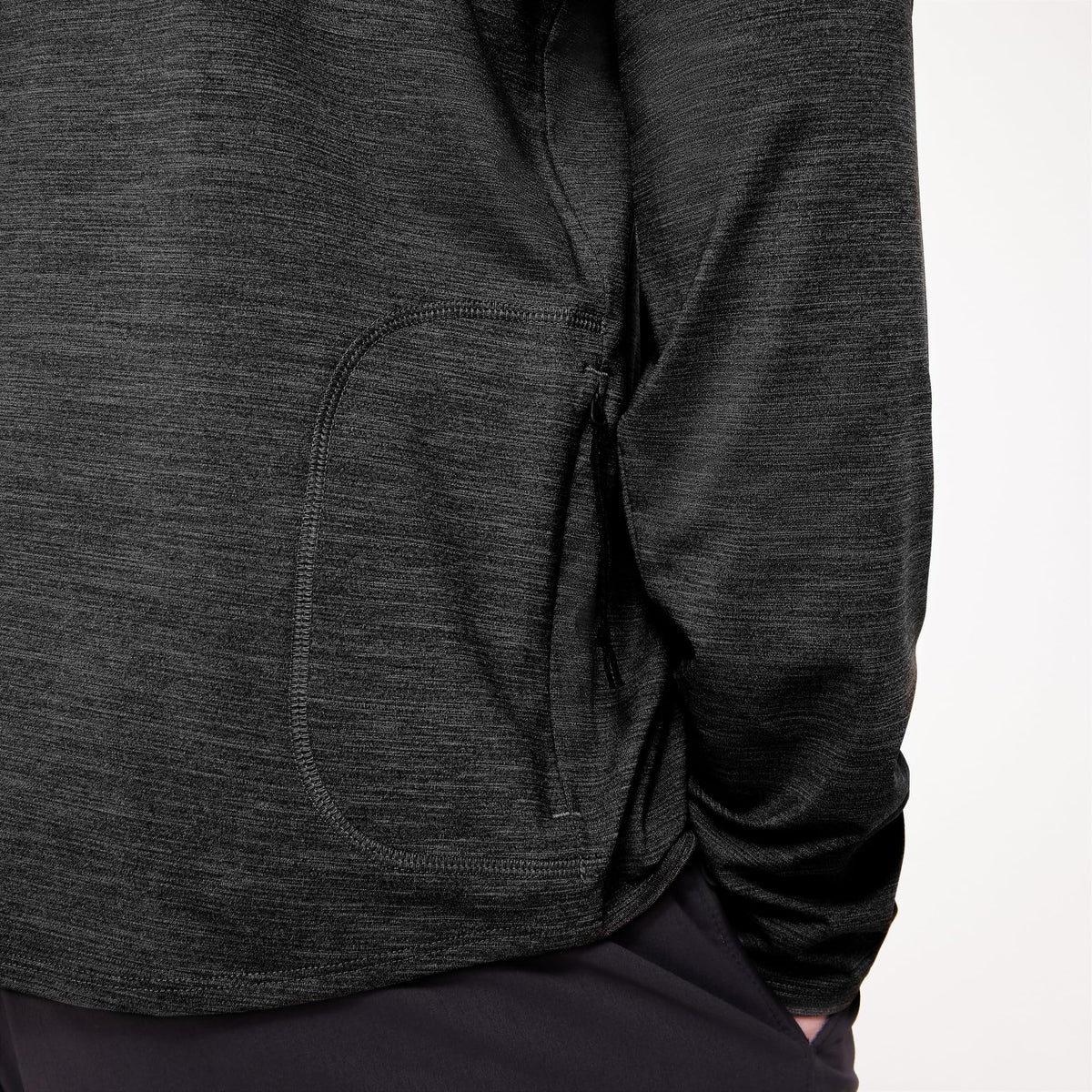 Men's black heather hoodie close-up of front pocket and hem with drawcord