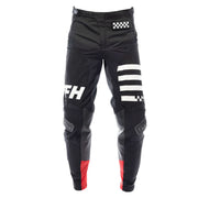 Black motorcycle riding pants with white stripe graphics, check patch, and red lower panels