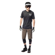 Black short-sleeve cycling jersey on model, chest checkered logo