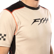 Cream short-sleeve jersey close-up with FTH logo and red-stitched shoulder panel