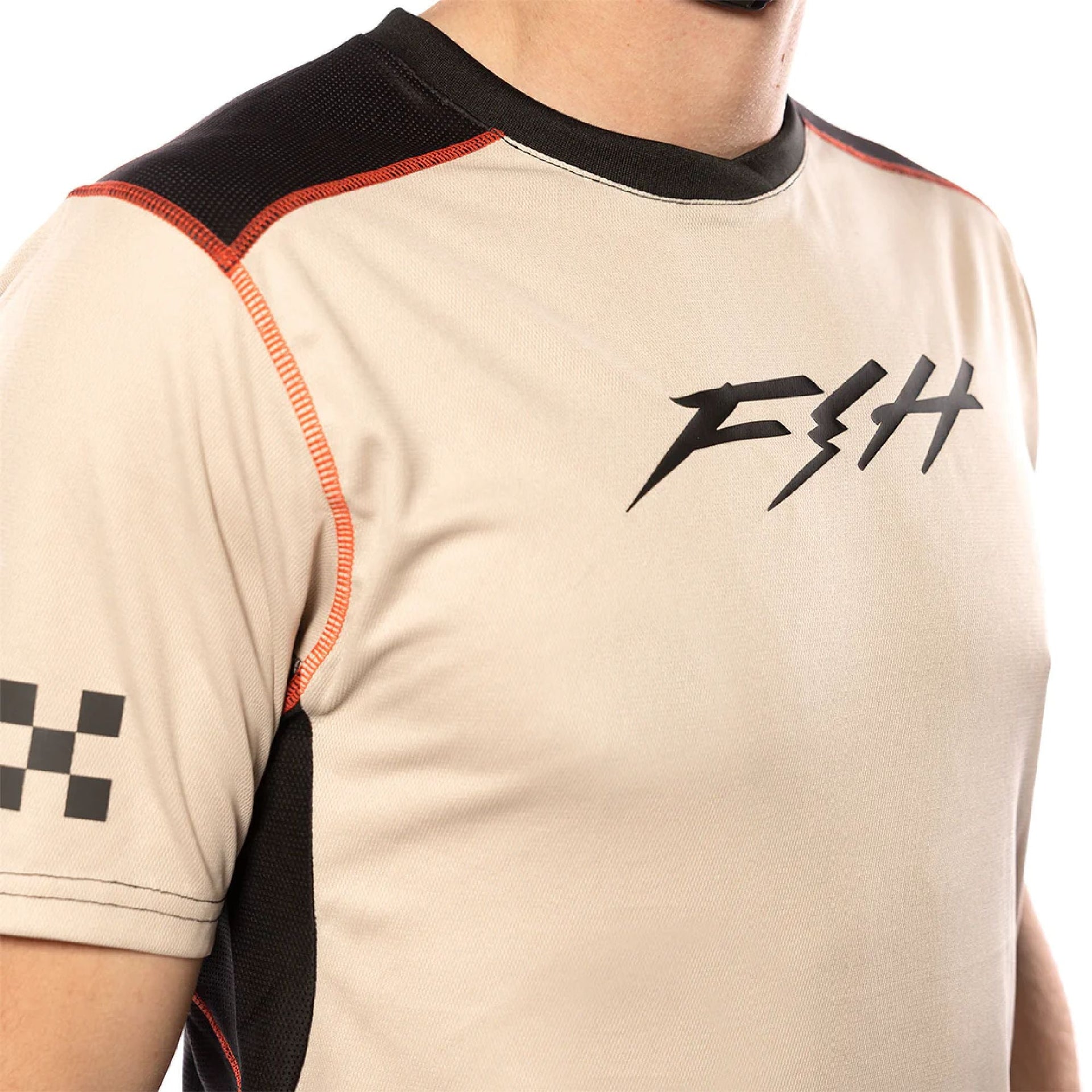 Cream short-sleeve jersey close-up with FTH logo and red-stitched shoulder panel