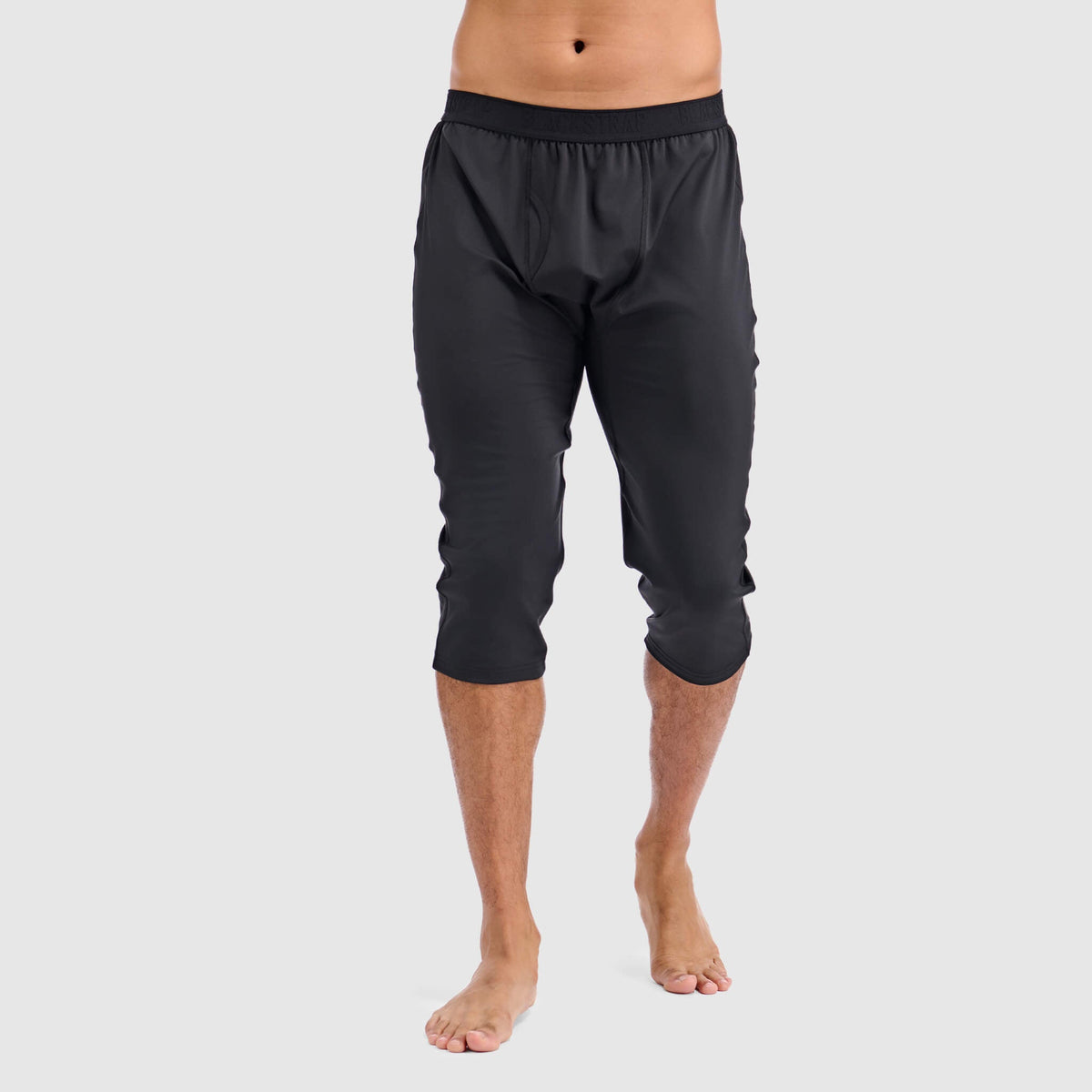 Black 3/4 baselayer pant, front view, elastic waistband and cropped cuffs