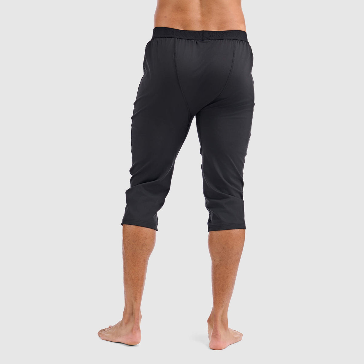 Black 3/4 baselayer pants, full back view, elastic waist and tapered legs