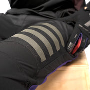 Close-up of black riding pants knee with gray reflective stripe graphic