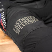 Black riding pants hip area with “EASTHOUSE SPEEDSHOP” lettering emblem