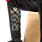 Black riding pants with checkered thigh panel and purple waistband accents
