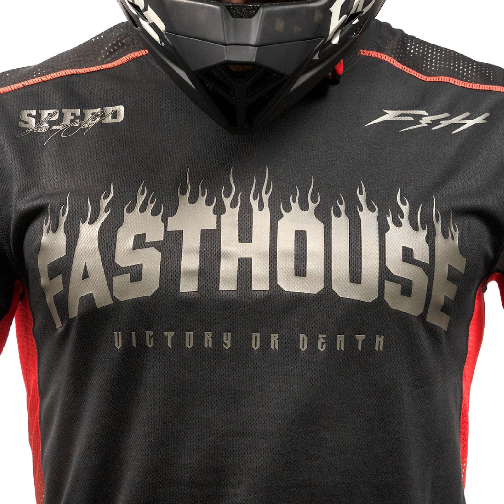 Youth black long-sleeve jersey close-up with Fasthouse flame logo and orange trim