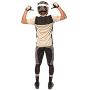 Cream jersey back view with dark patterned panel and small sleeve logos